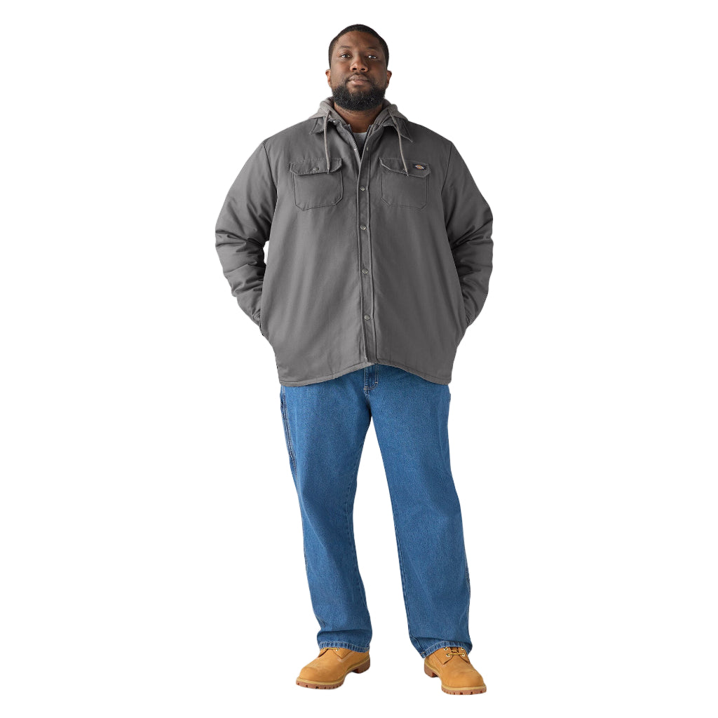 Man wearing a gray jacket, blue jeans, and brown boots on a white background