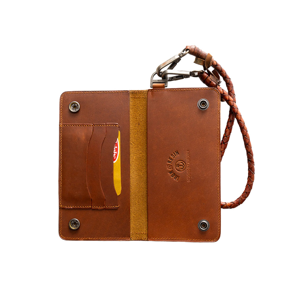 Brown leather trucker wallet laid flat showing the pockets