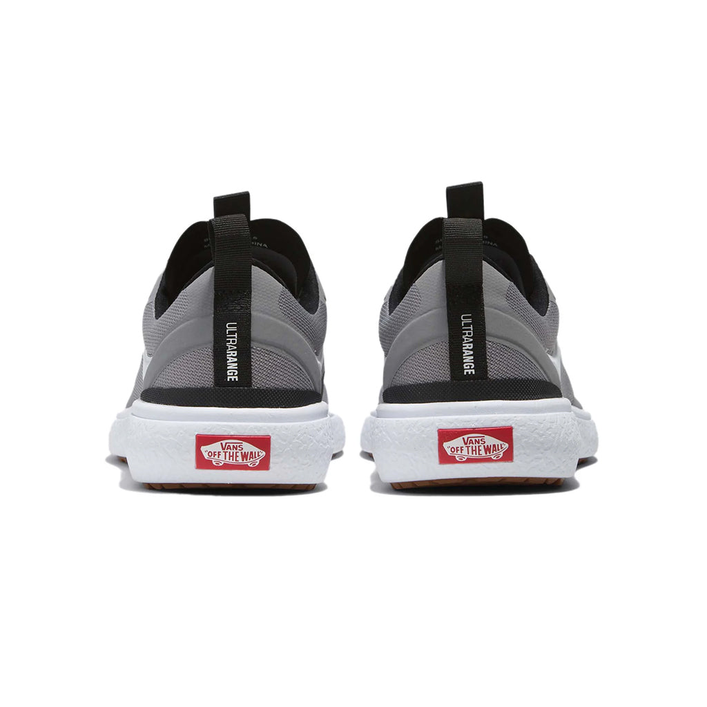 Gray and black Vans shoes with red label on a white background