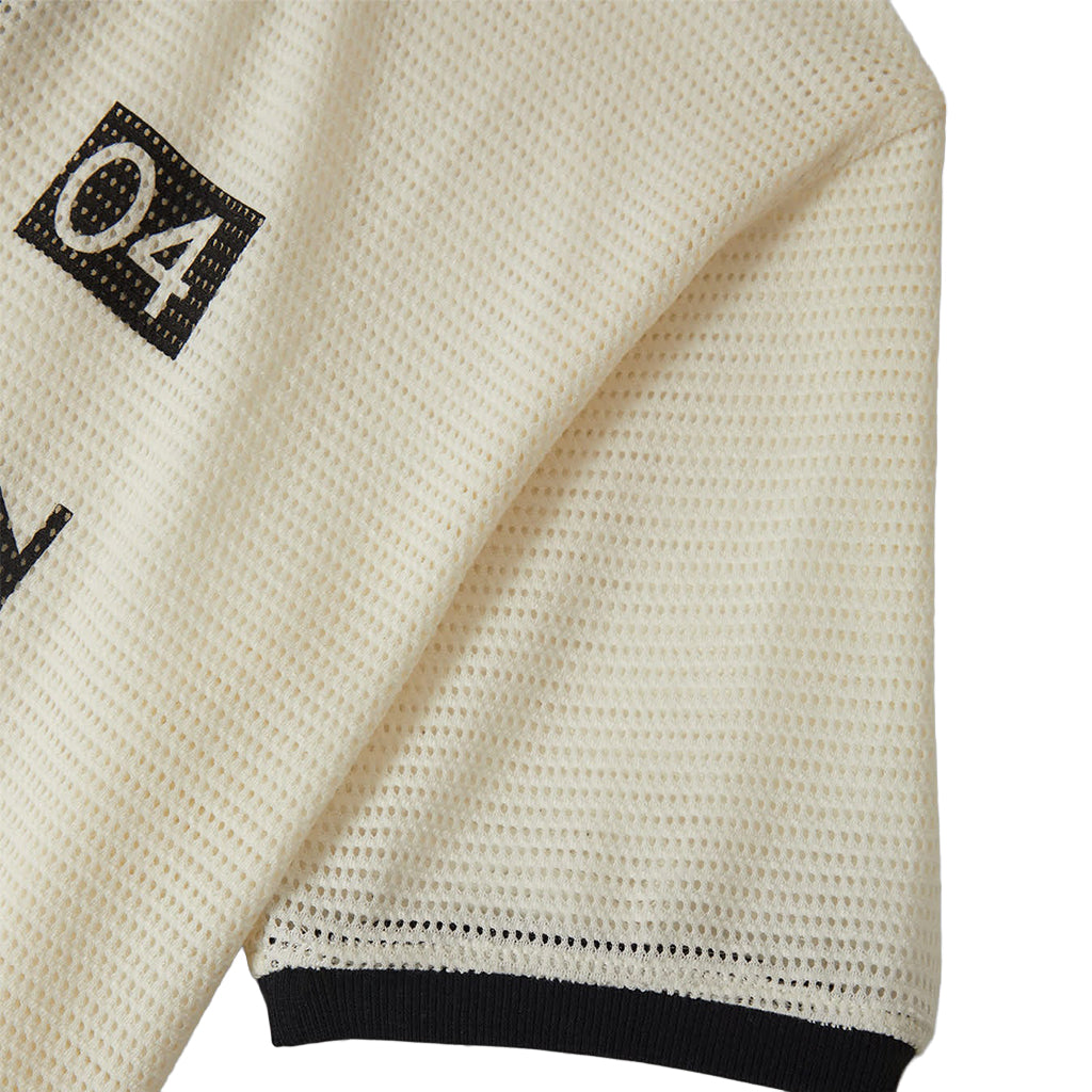 Close-up of a textured beige fabric with black lettering on a white background
