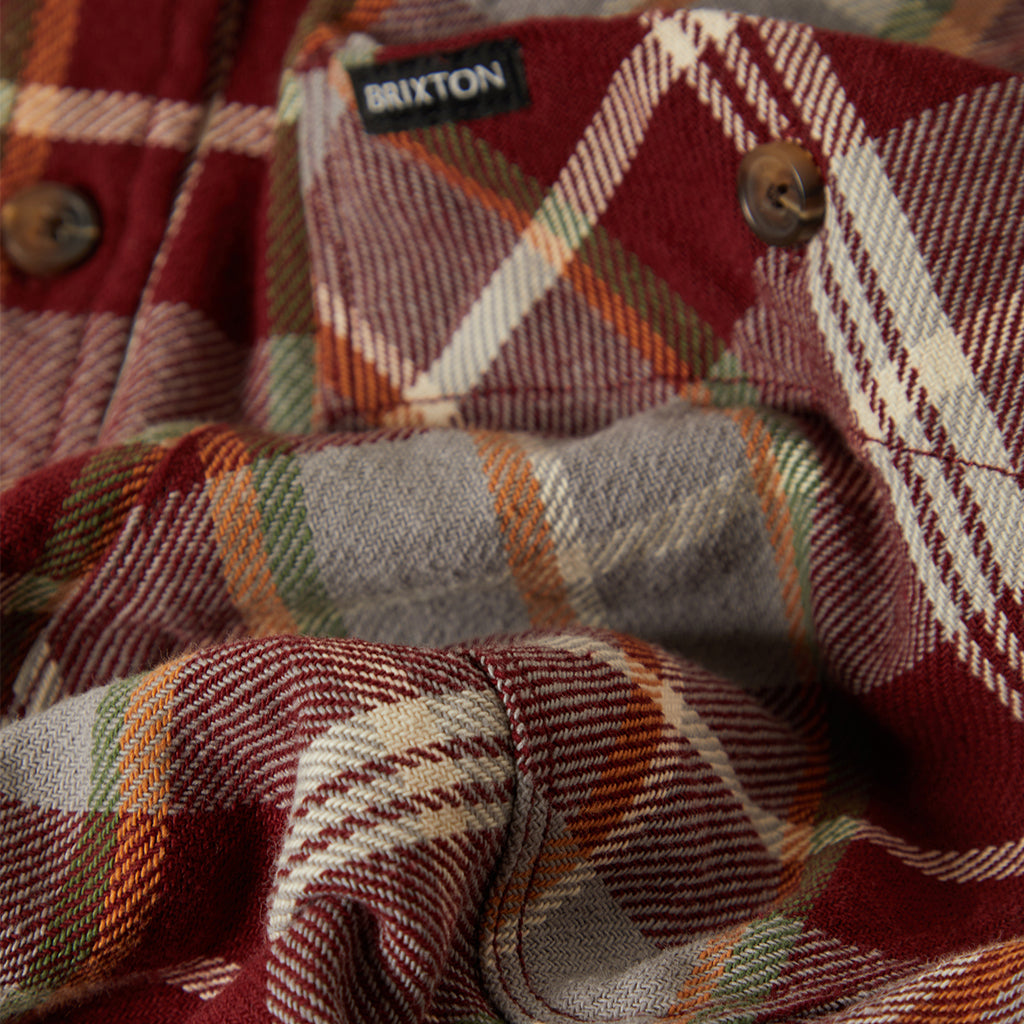 Close up of red, green, grey flannel with brixton label in the back