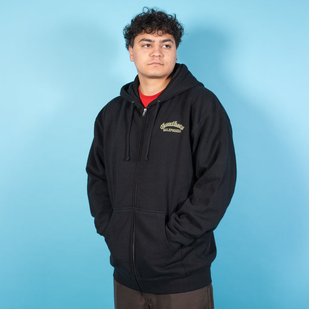 Person wearing a black hoodie with text on a blue background