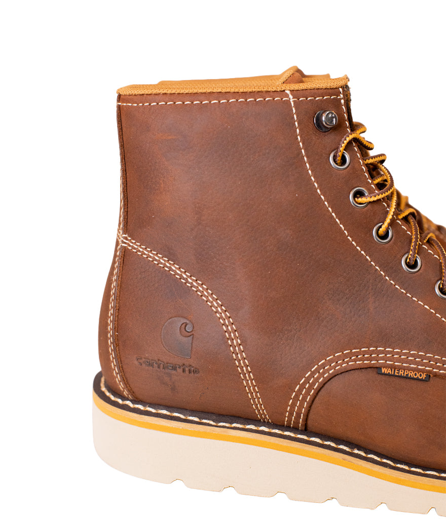 Brown leather boot with visible Carhartt logo on a white background