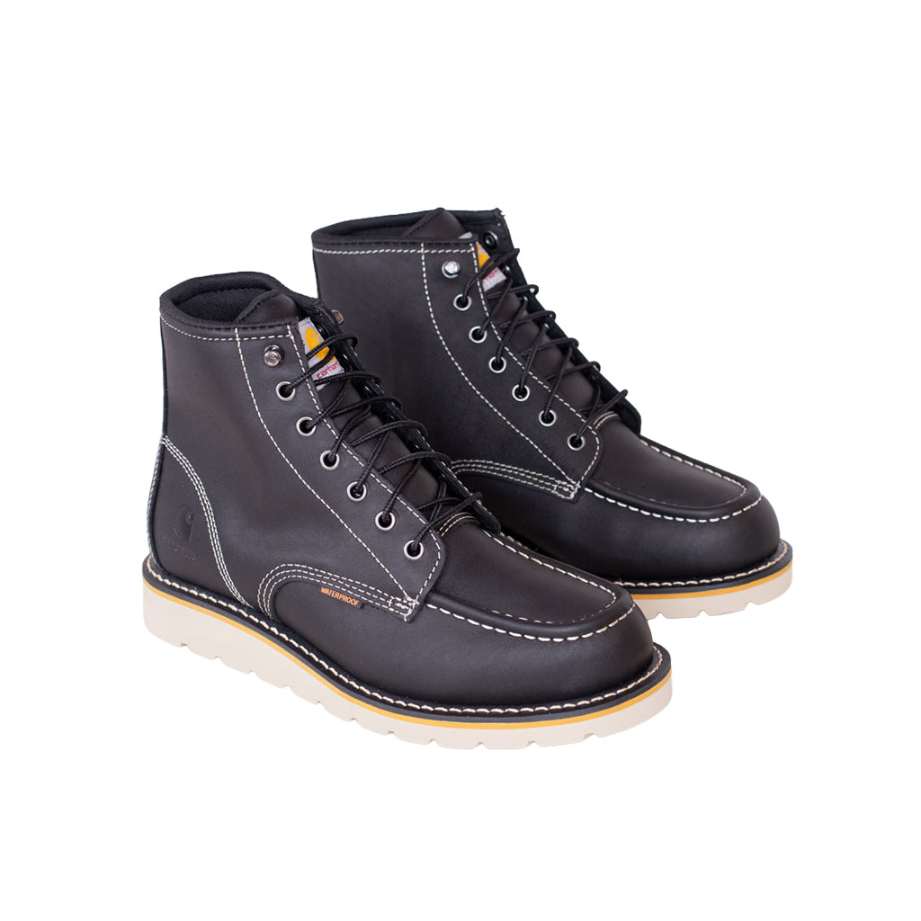 Pair of black leather boots with white soles on a white background