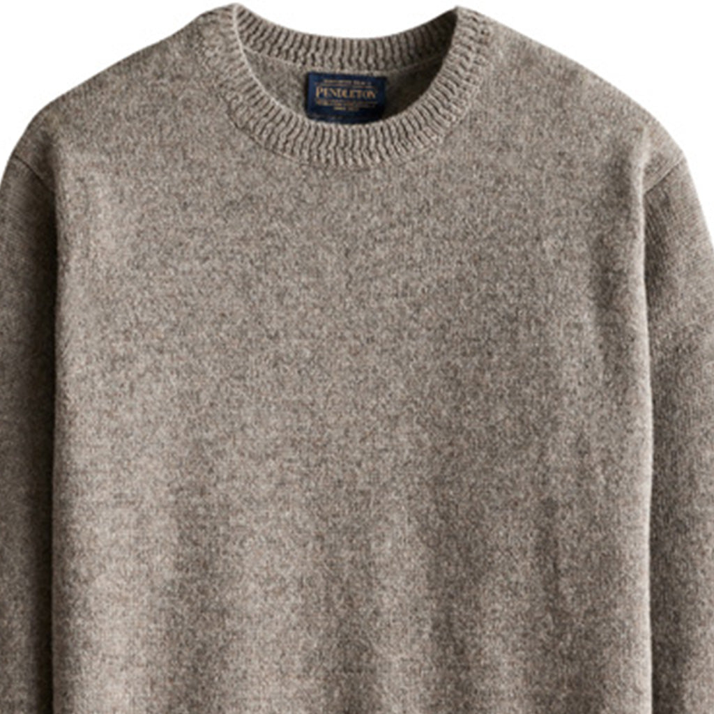 Gray sweater with a brand label on a white background