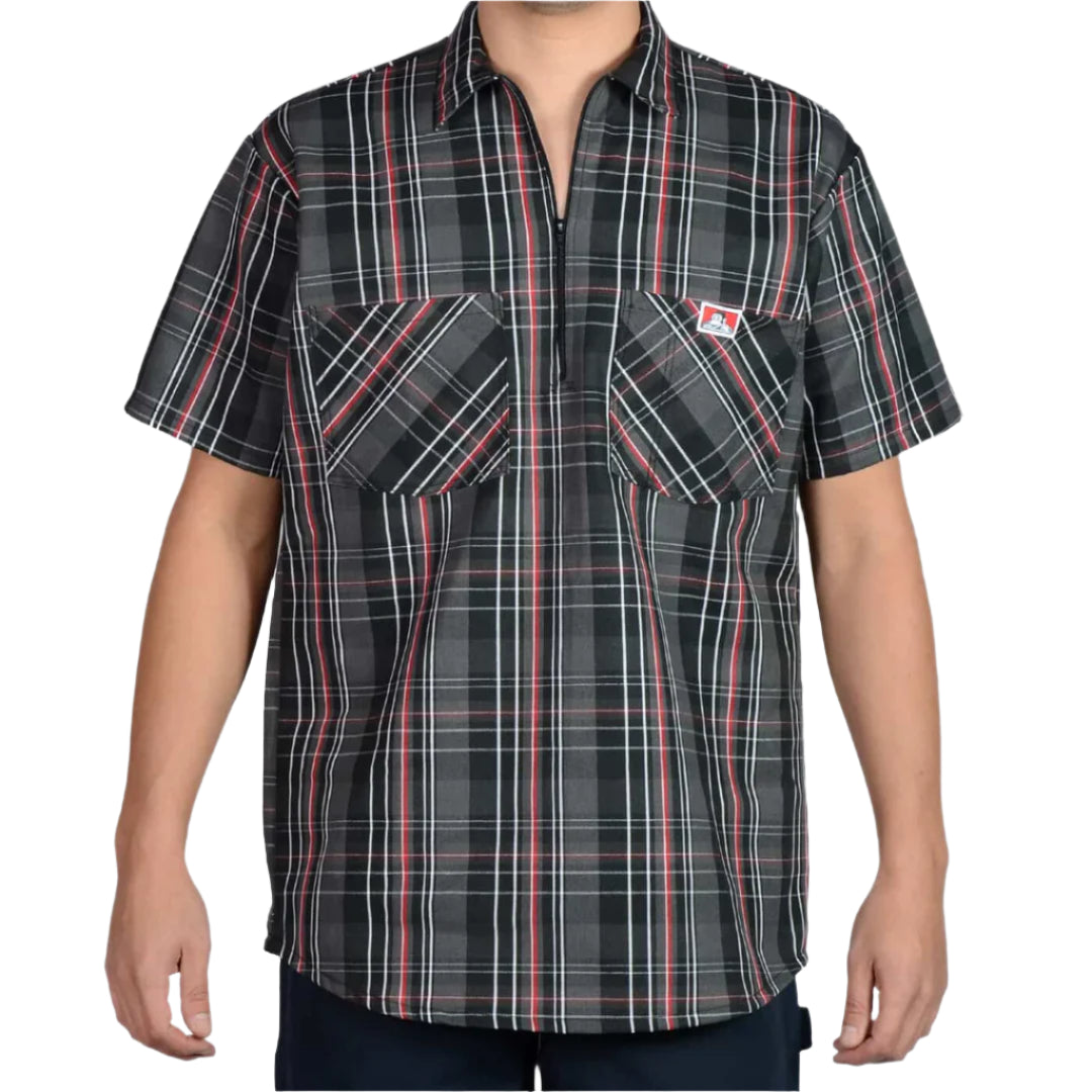 A short-sleeved, half-zip black and red plaid shirt with two chest pockets and a pencil pouch on the left pocket.