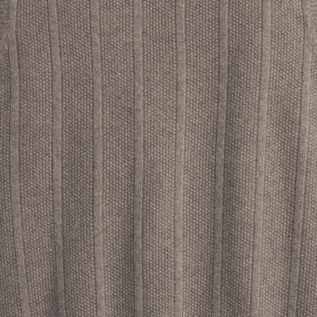 Close-up of a textured brown fabric surface