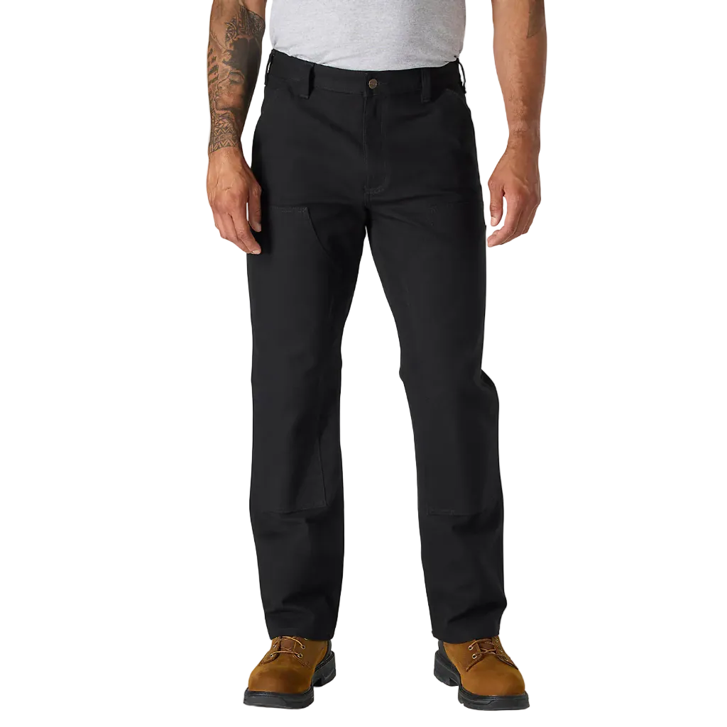 Person wearing black pants and brown shoes on a white background