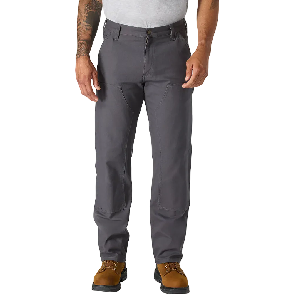 Person wearing gray pants and brown shoes on a white background