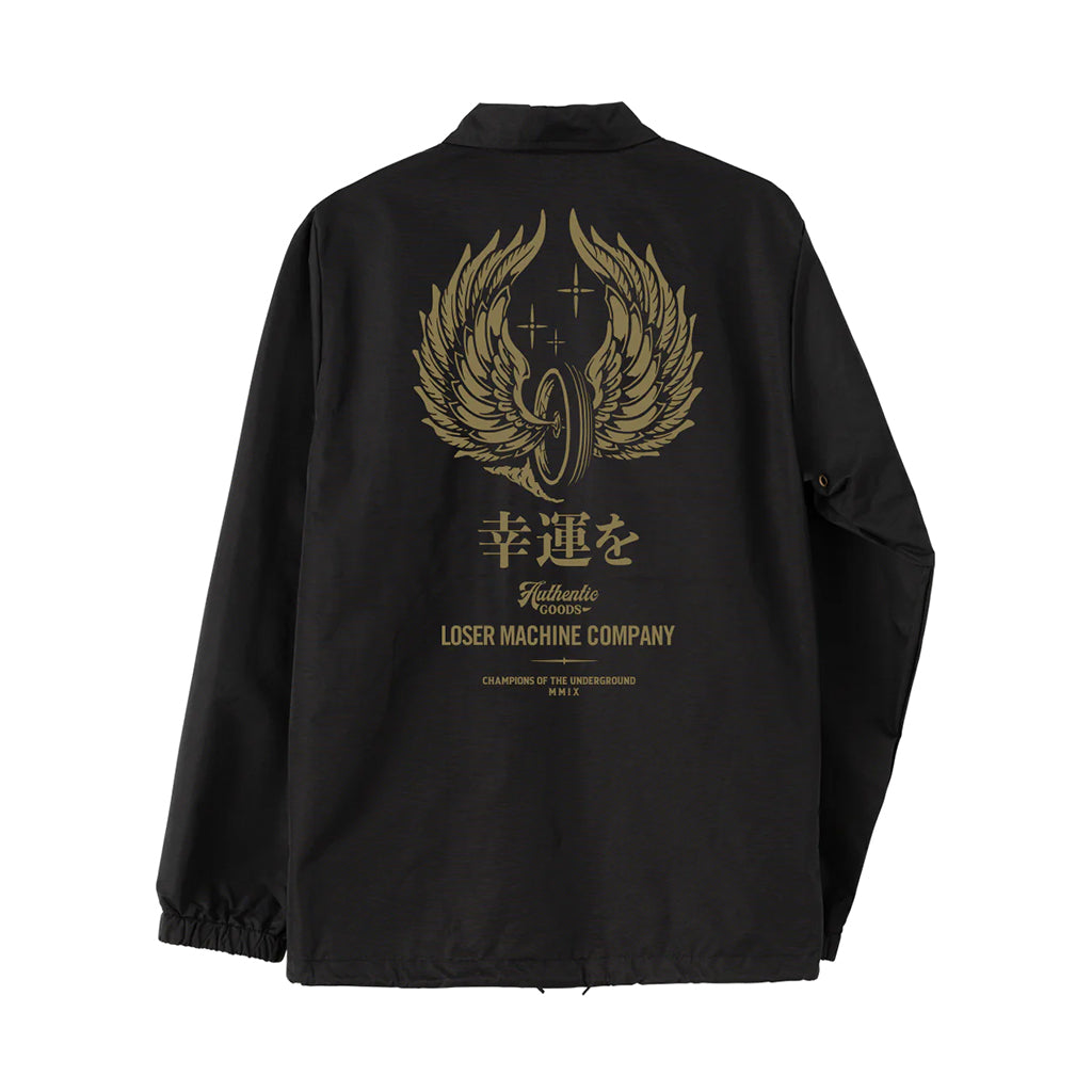 A black nylon coach's jacket with metallic ink print on the back featuring wings and Japanese characters.
