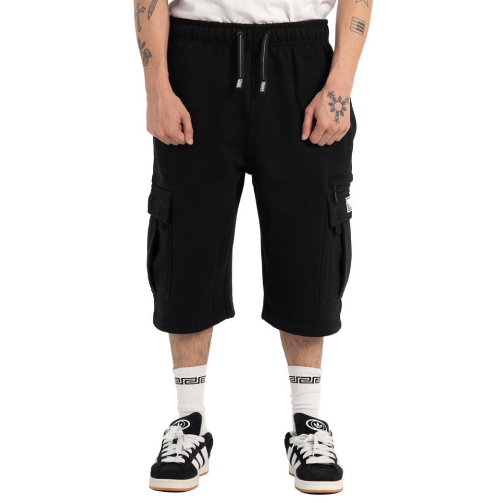 Person wearing black cargo shorts on a white background