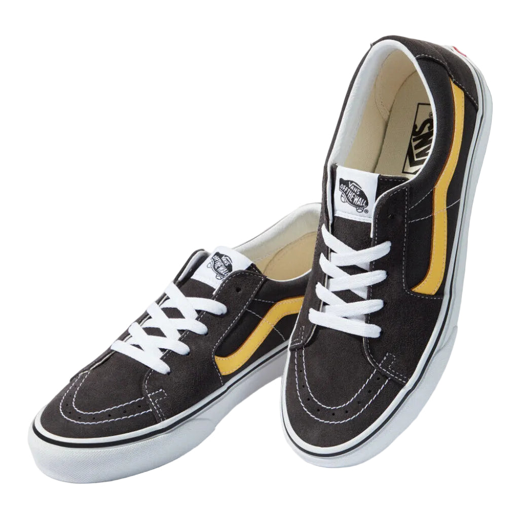 Pair of black and yellow Vans sneakers on a white background