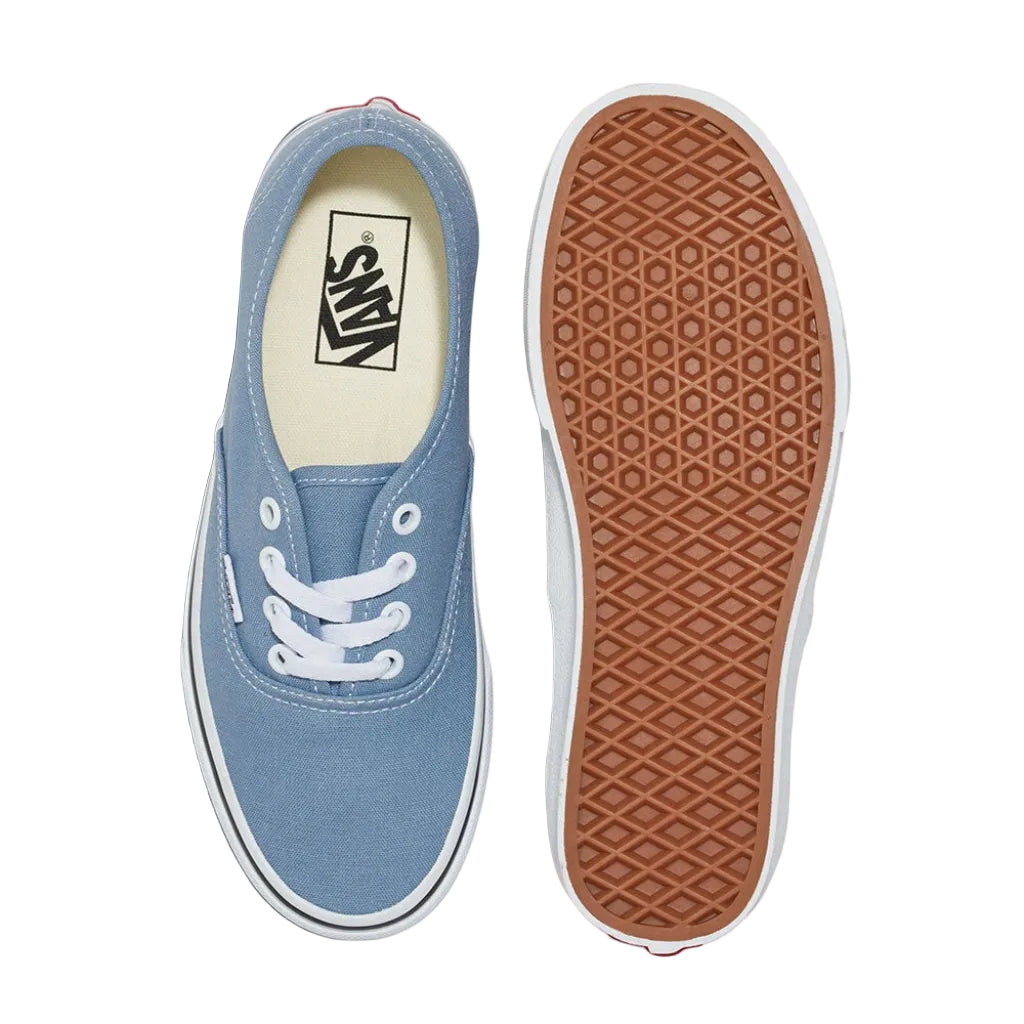 Blue Vans sneaker with white laces on a white background