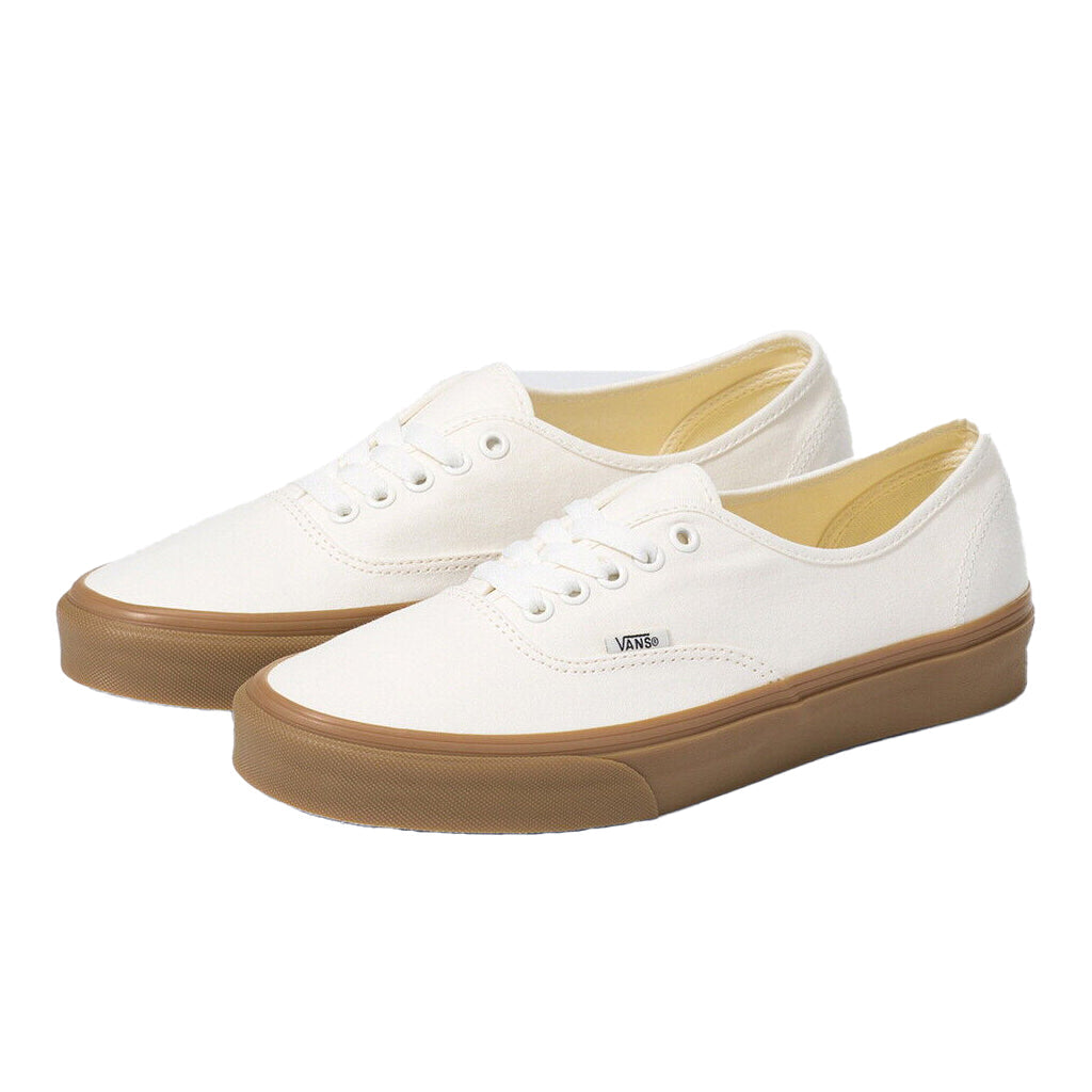 White sneakers with brown soles on a white background