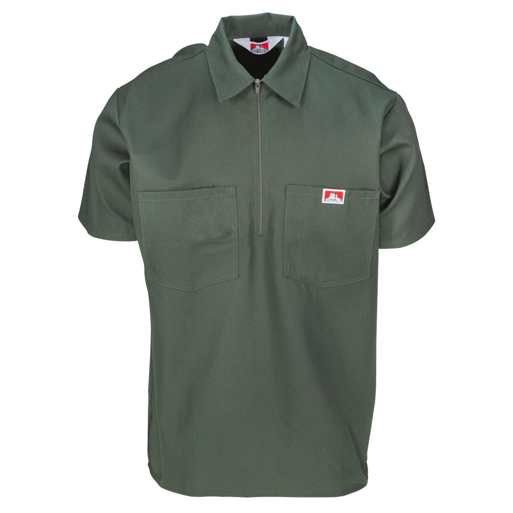 A short sleeve olive green shirt with a half zipper and two chest pockets.