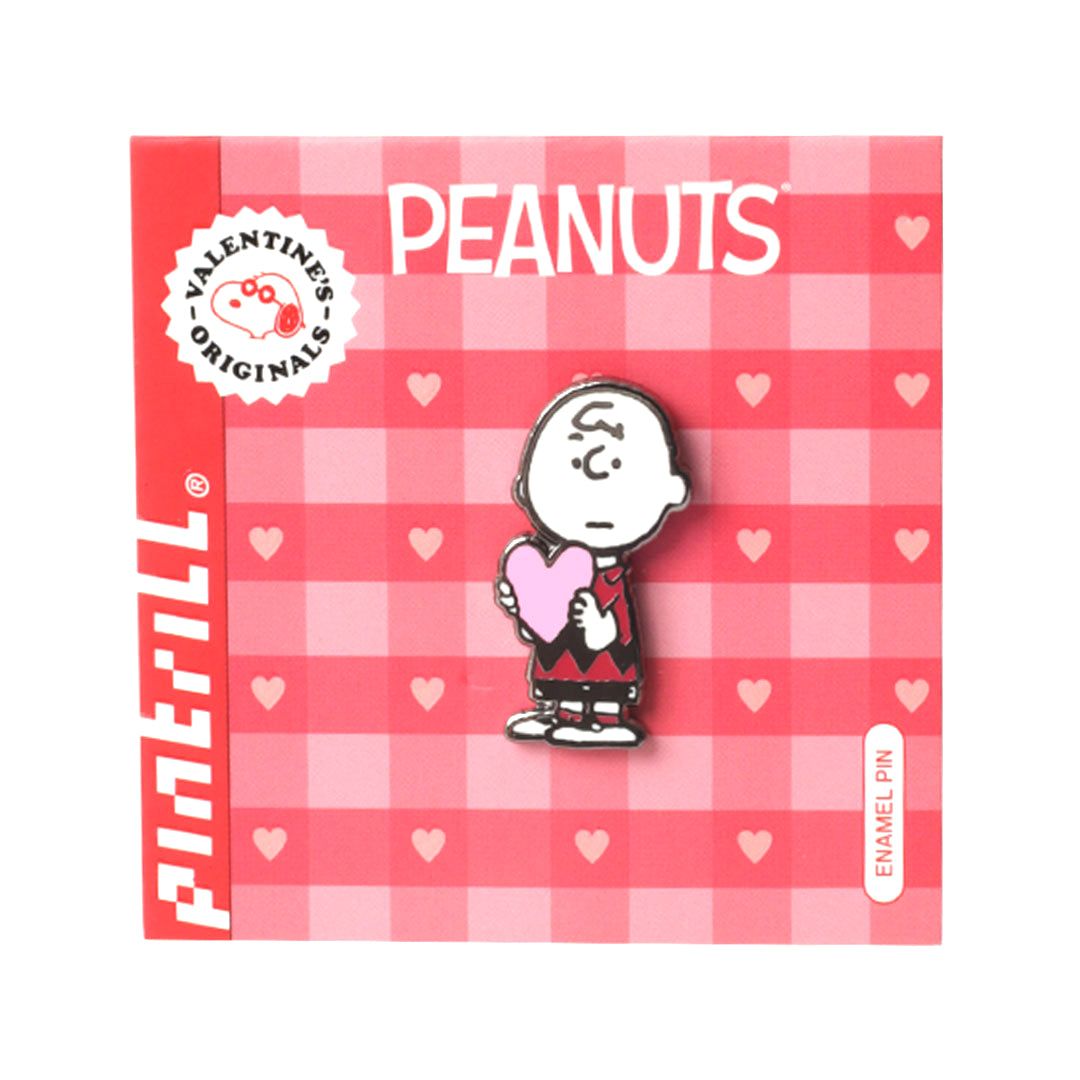 Peanuts-themed enamel pin with Charlie Brown holding a heart on a red checkered background.