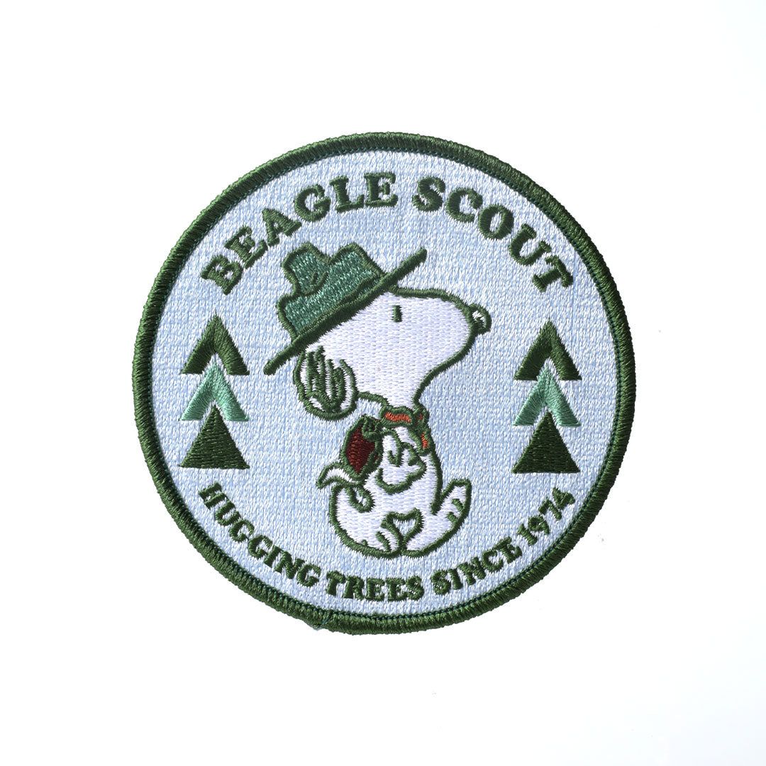 Patch with Snoopy as a beagle scout and text 'Beagle Scout Hugging Trees Since 1970' on a white background