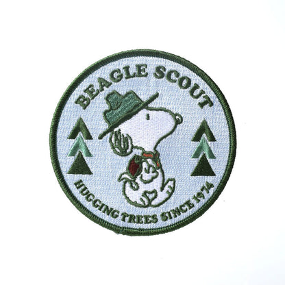 Patch with Snoopy as a beagle scout and text 'Beagle Scout Hugging Trees Since 1970' on a white background