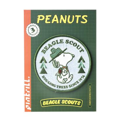 Peanuts-themed beagle scout patch on a green card with 'Peanuts' branding.