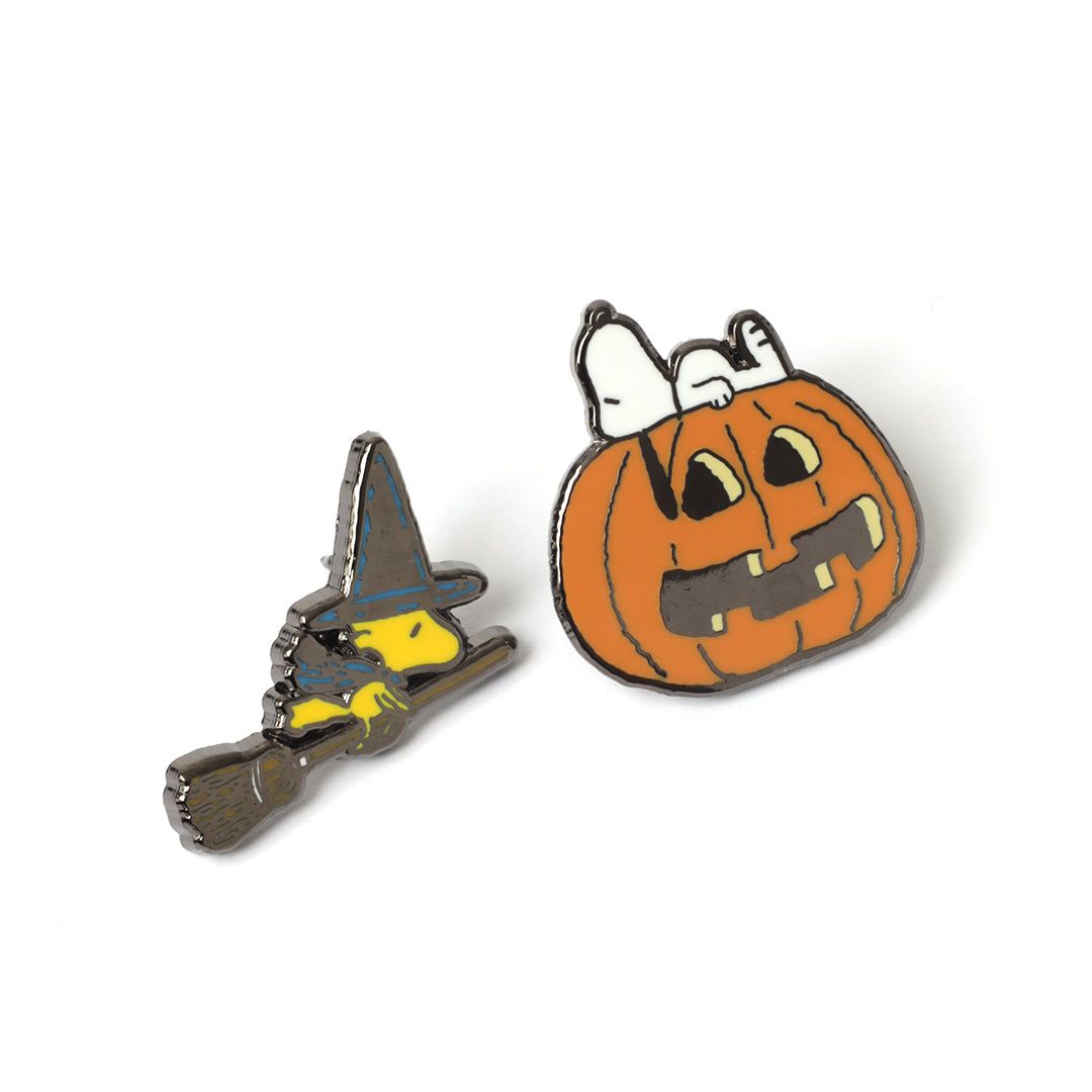 Snoopy and Woodstock Halloween-themed pins, one of a witch and the other of a pumpkin with a face, on a white background.