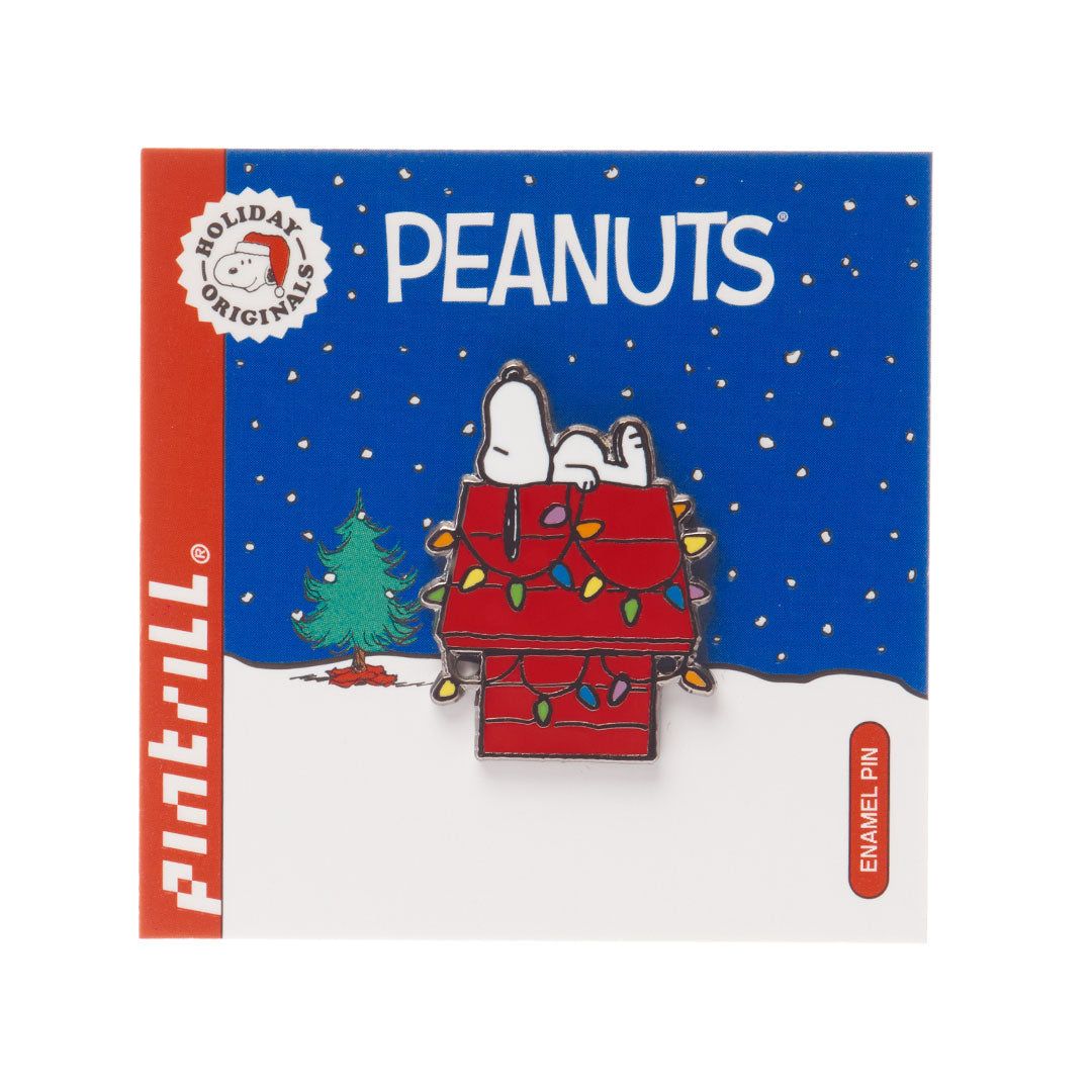 Peanuts enamel pin packaging with Snoopy on a tree house, Christmas tree, and snow.