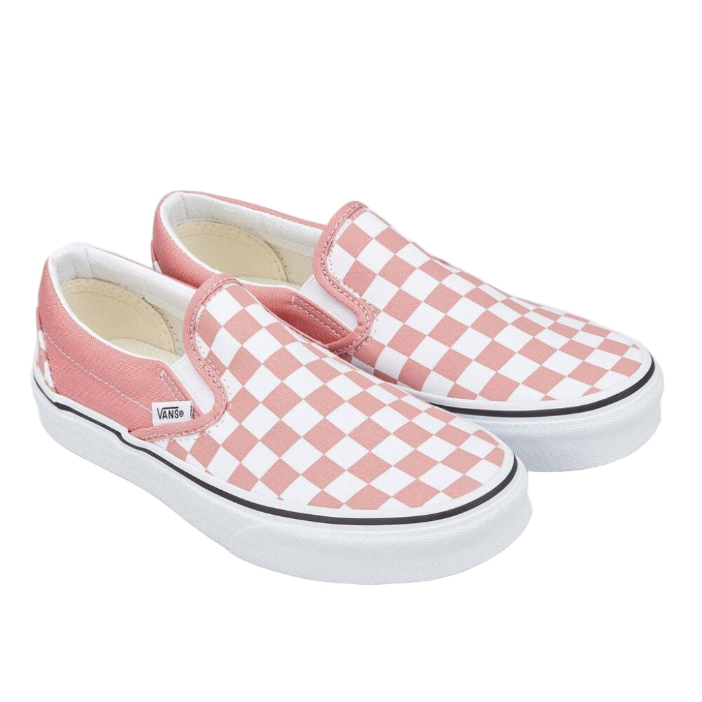 Pair of pink and white checkered Vans slip-on shoes on a white background