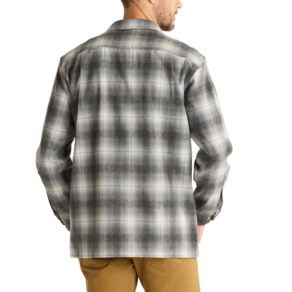 Man wearing a gray plaid shirt on a white background