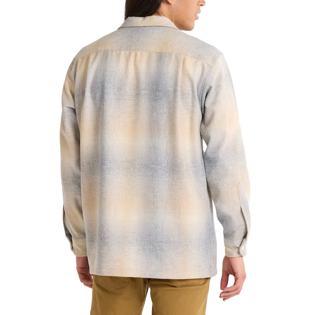 Person wearing a patterned shirt with a white background
