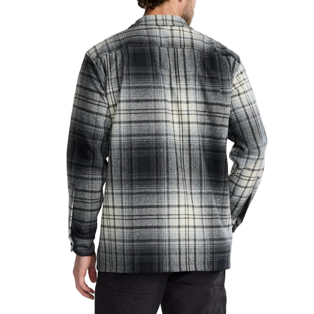 Man wearing a plaid shirt with a white background