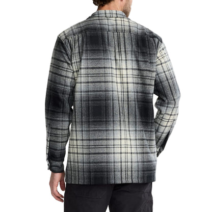 Man wearing a plaid shirt with a white background