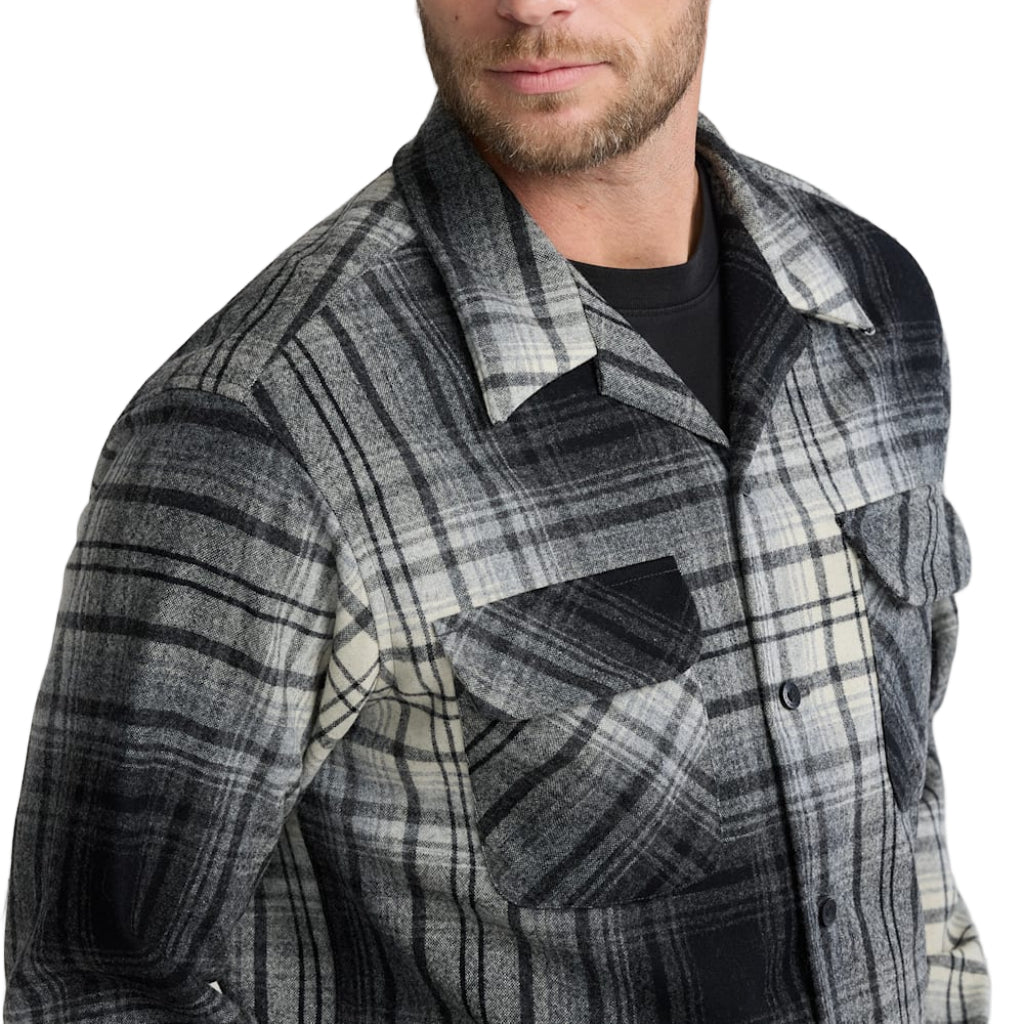 Man wearing a plaid shirt against a white background