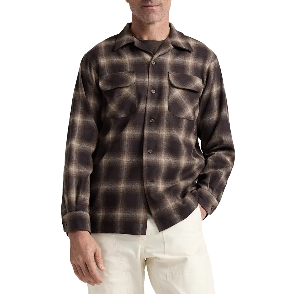 Man wearing a brown plaid shirt on a white background