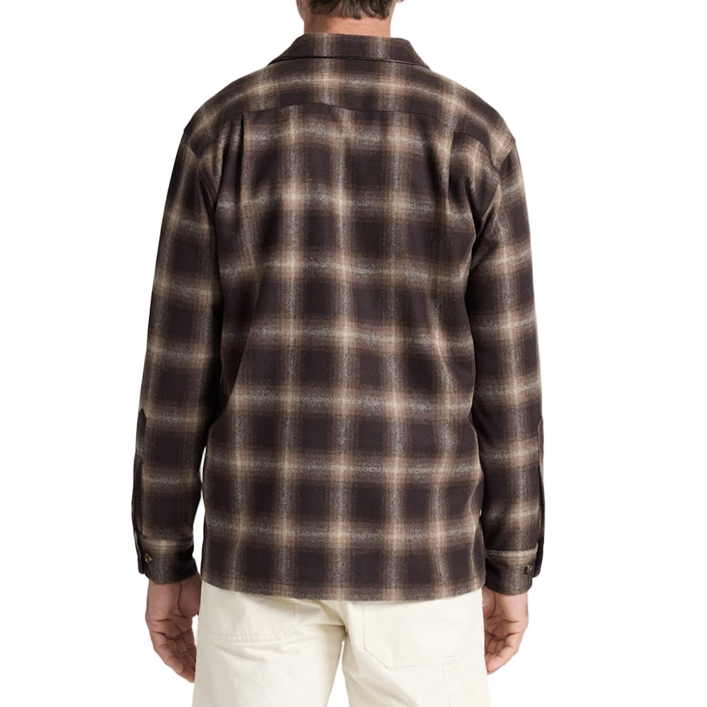 Man wearing a brown plaid shirt on a white background
