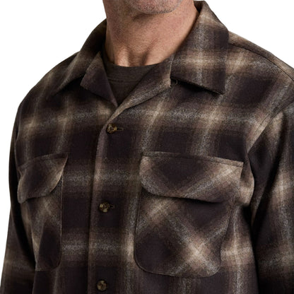Plaid shirt worn by a person on a plain white background