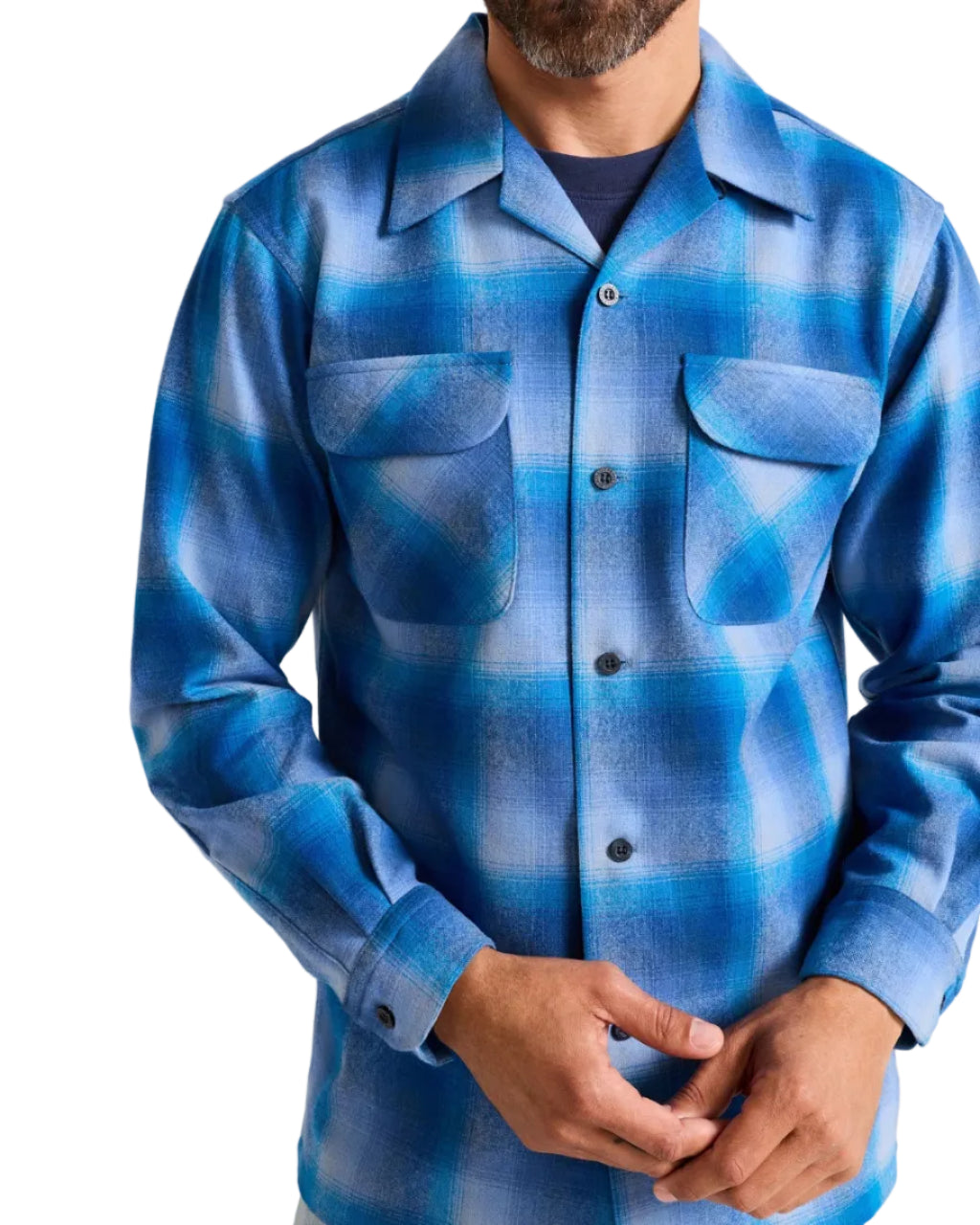 Blue plaid shirt worn by a person on a plain background