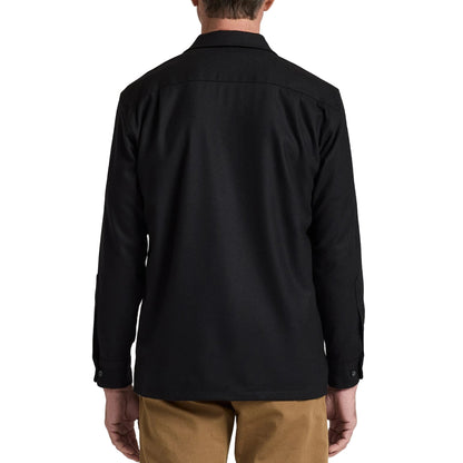 Man wearing a black shirt and brown pants against a white background