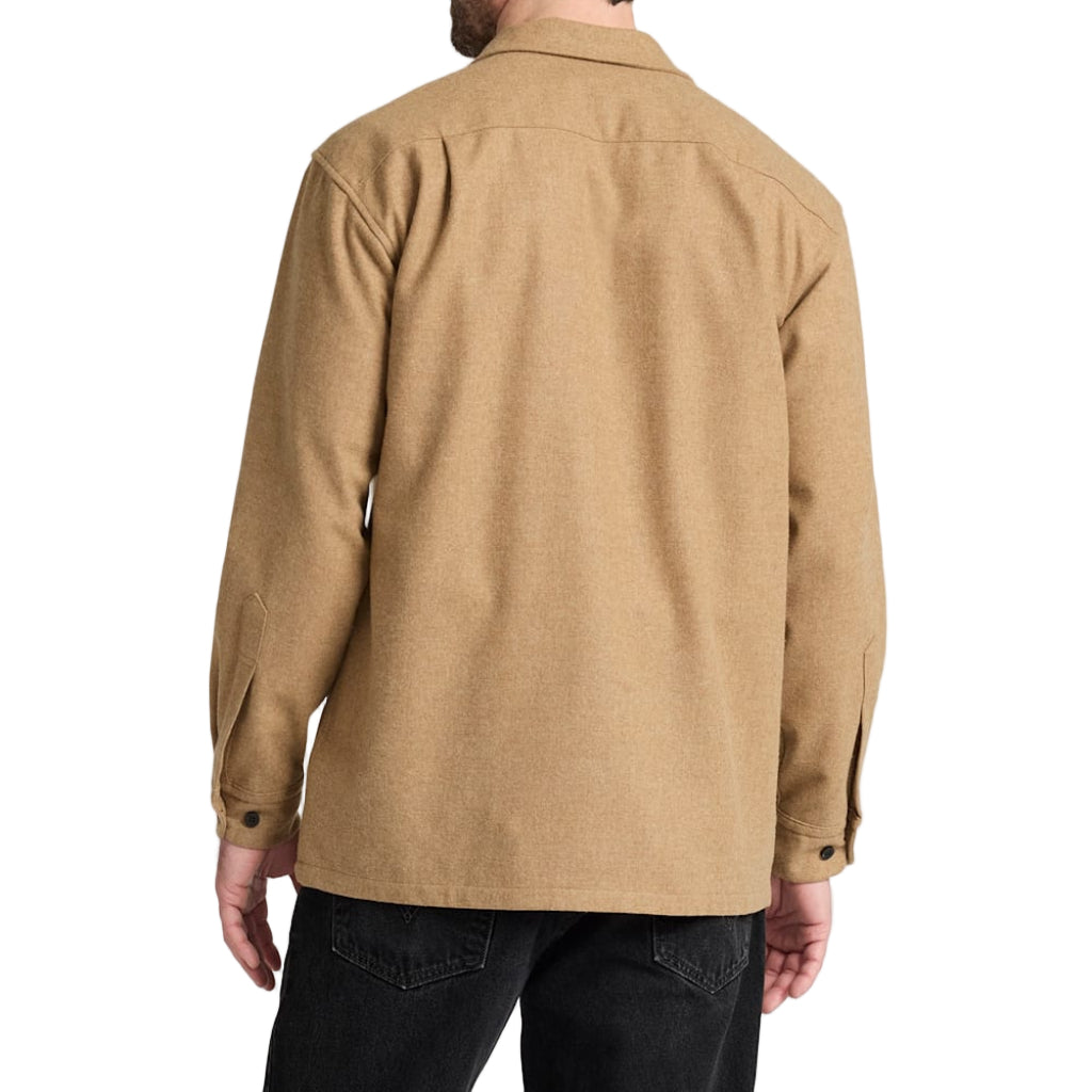 Man wearing a beige shirt on a white background