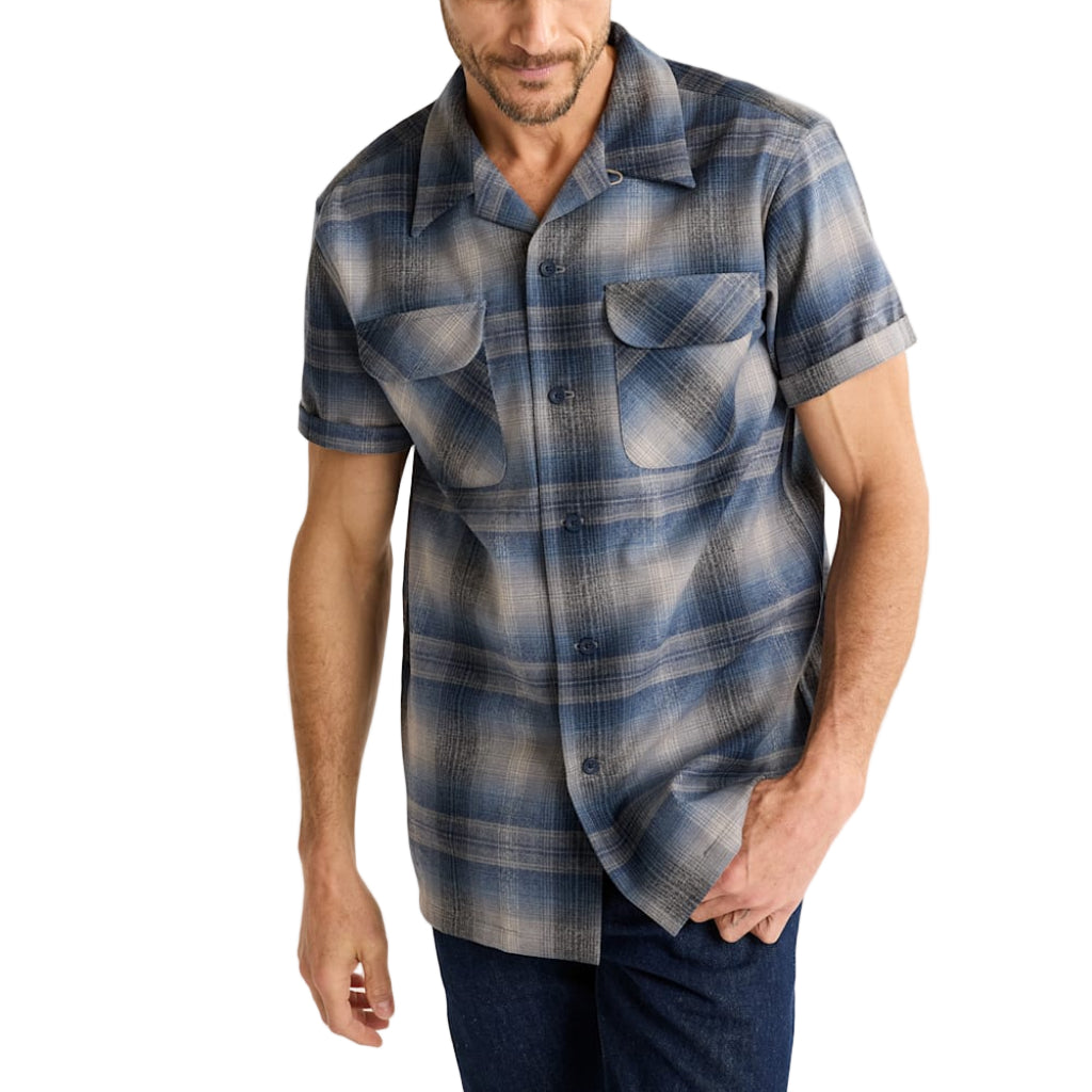 Man wearing a blue plaid short-sleeve shirt on a white background