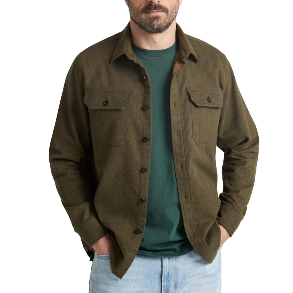 Man wearing a green shirt over a green t-shirt on a white background