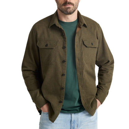 Man wearing a green shirt over a green t-shirt on a white background