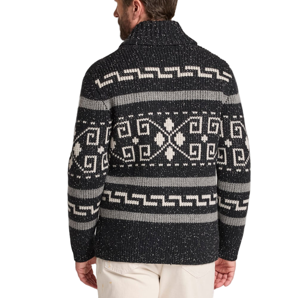 Man wearing a black patterned sweater on a white background
