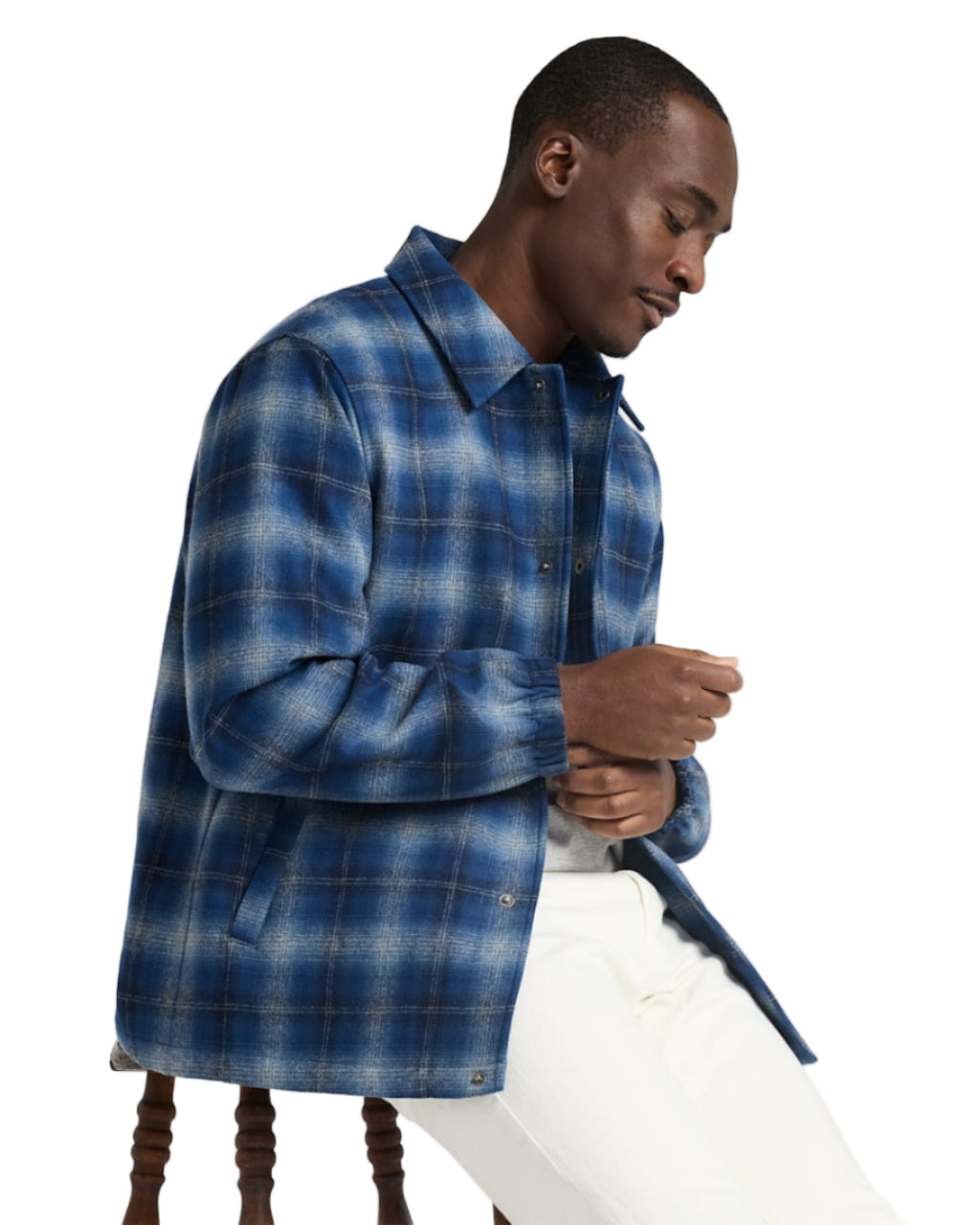 Man wearing a blue plaid shirt against a white background