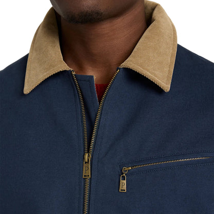 Navy blue jacket with beige collar and gold zipper on a neutral background