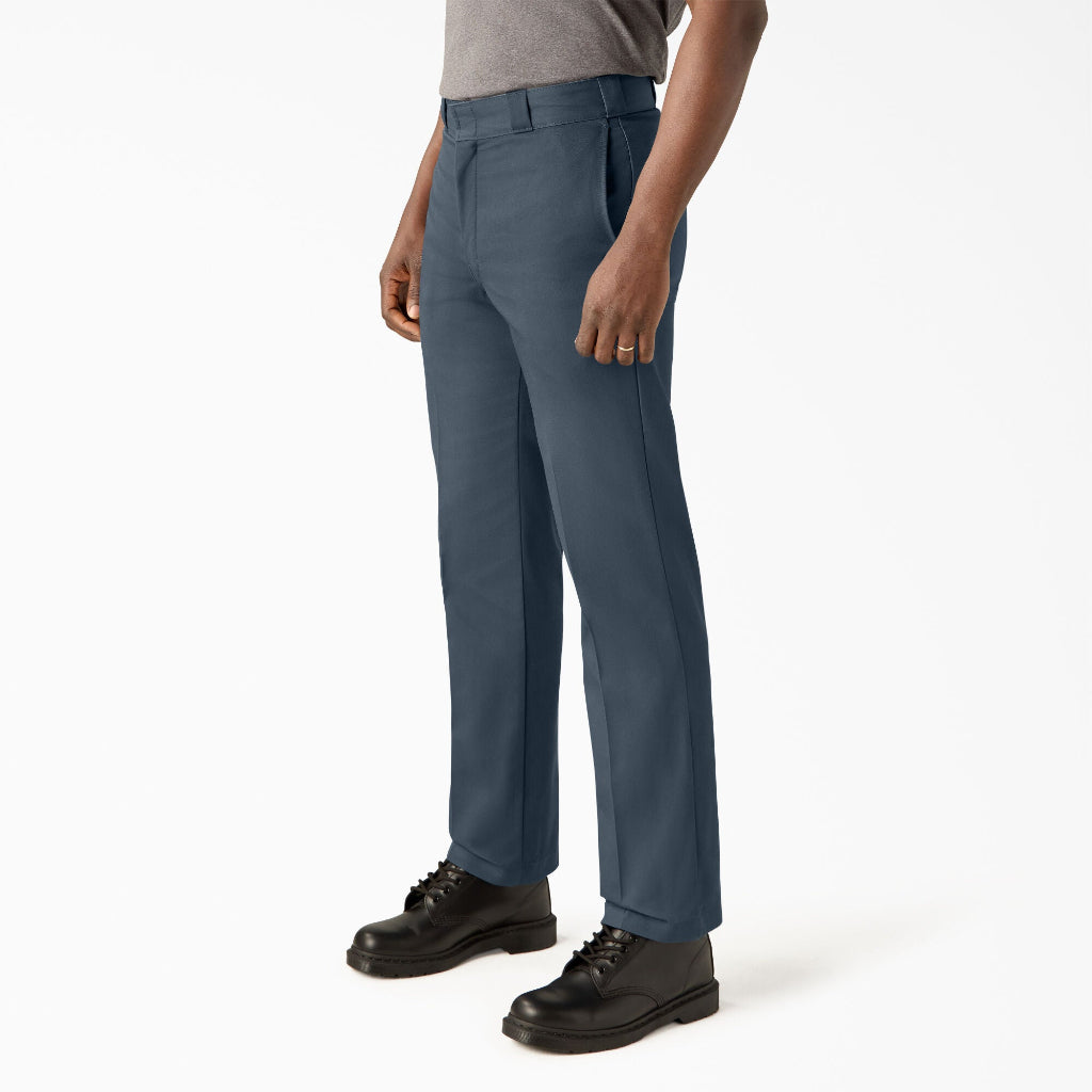 Person wearing blue pants and black shoes on a white background