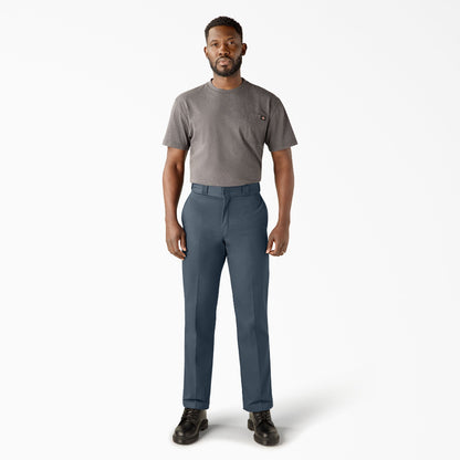 Man wearing a gray t-shirt and blue pants on a white background