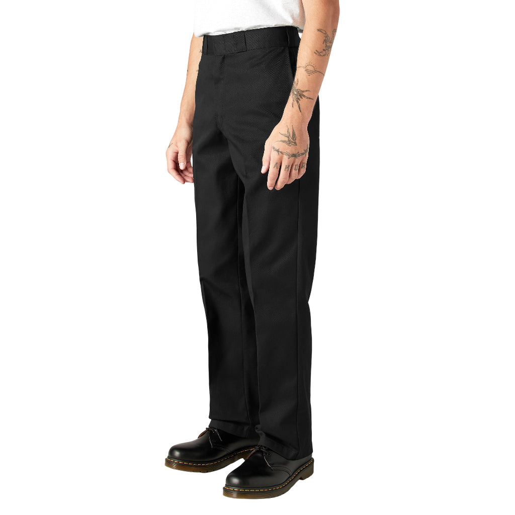 Person wearing black pants and black shoes on a white background