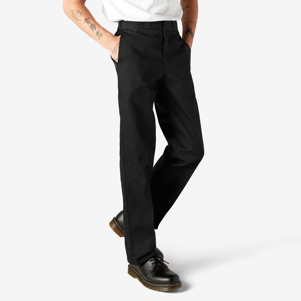Person wearing black pants and black shoes on a white background