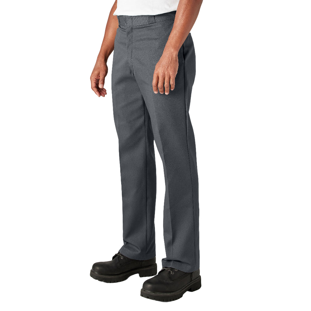 Person wearing gray pants and black shoes on a white background
