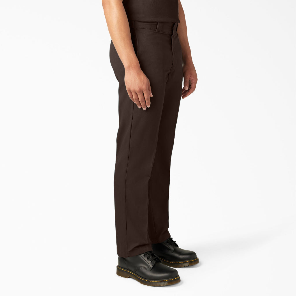 Person wearing brown pants and black shoes on a white background