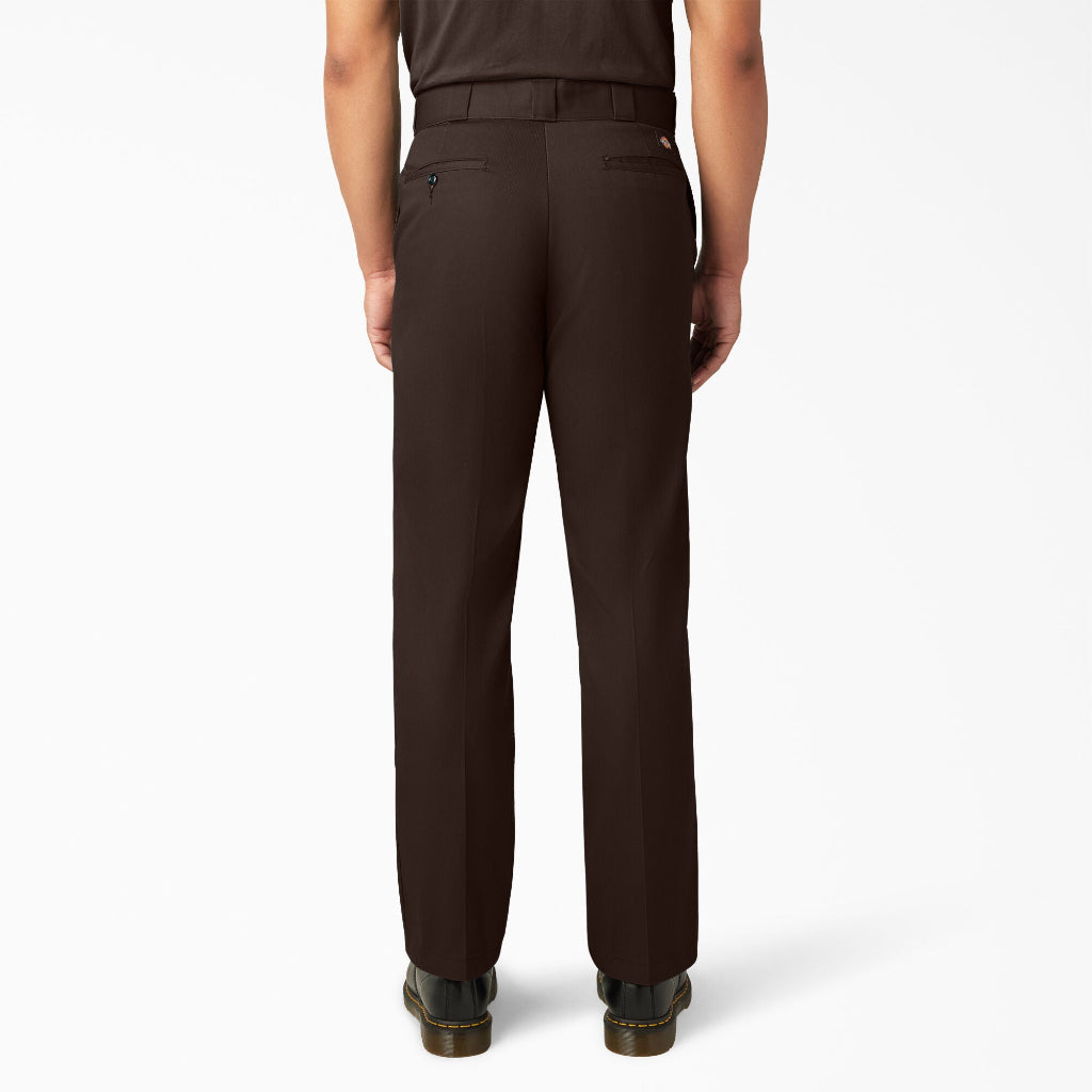 Dark brown pants worn by a person on a white background